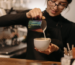woman making coffee in one of Pataakhaa's best coffee mugs